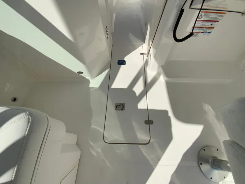 Slide: The Image of 2025 Pursuit DC 246 Dual Console interior with storage compartment and seating. - 27