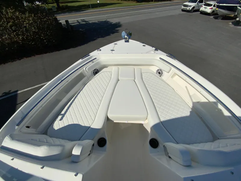 Slide: The Image of 2025 Pursuit DC 246 Dual Console boat with spacious white seating area. - 29