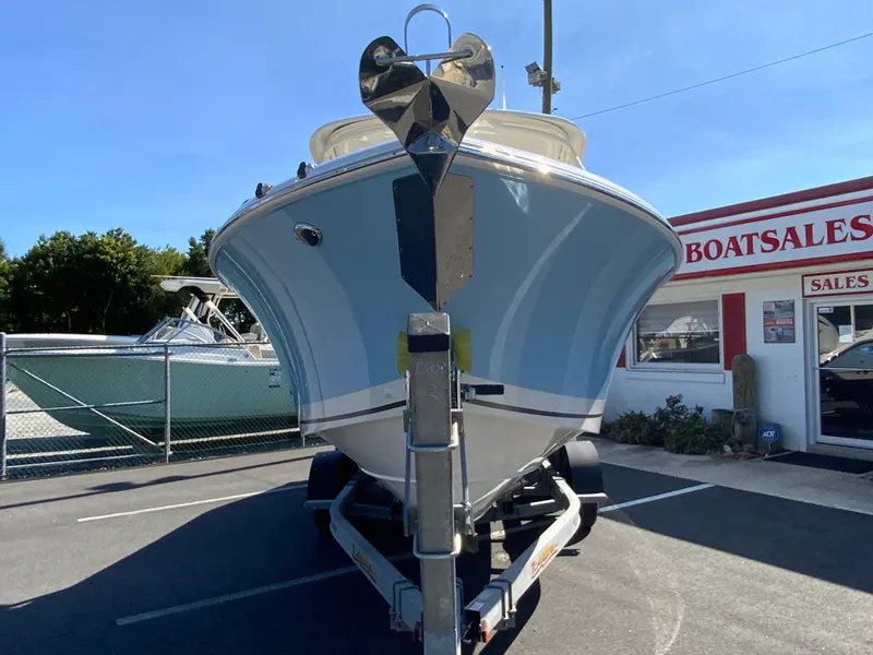 Slide: The Image of 2025 Pursuit DC 246 Dual Console boat on trailer at dealership. - 3
