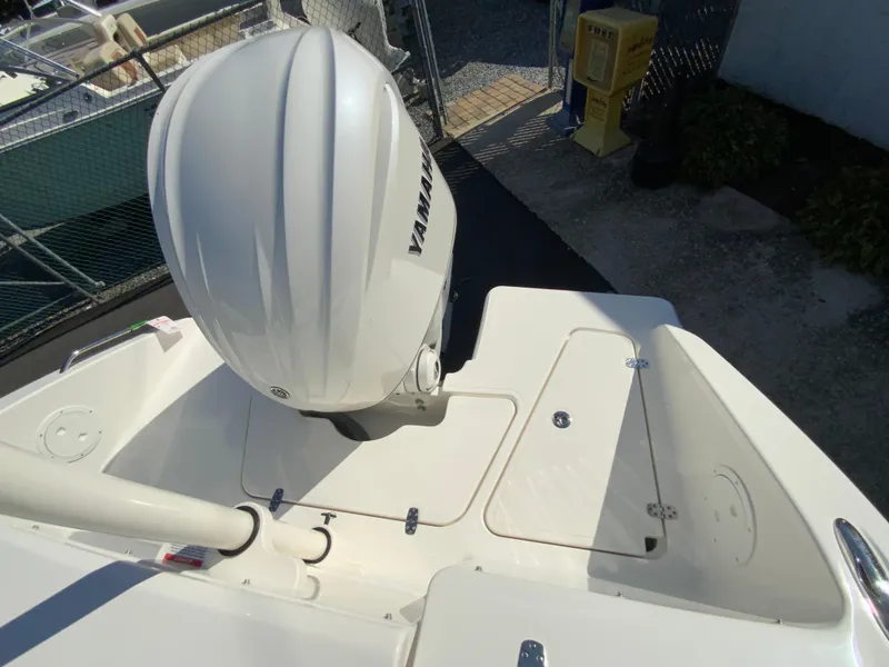 Slide: The Image of 2025 Pursuit DC 246 Dual Console boat with Yamaha outboard engine, rear deck view. - 30