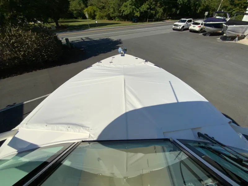 Slide: The Image of 2025 Pursuit DC 246 Dual Console boat with cover in parking lot. - 32