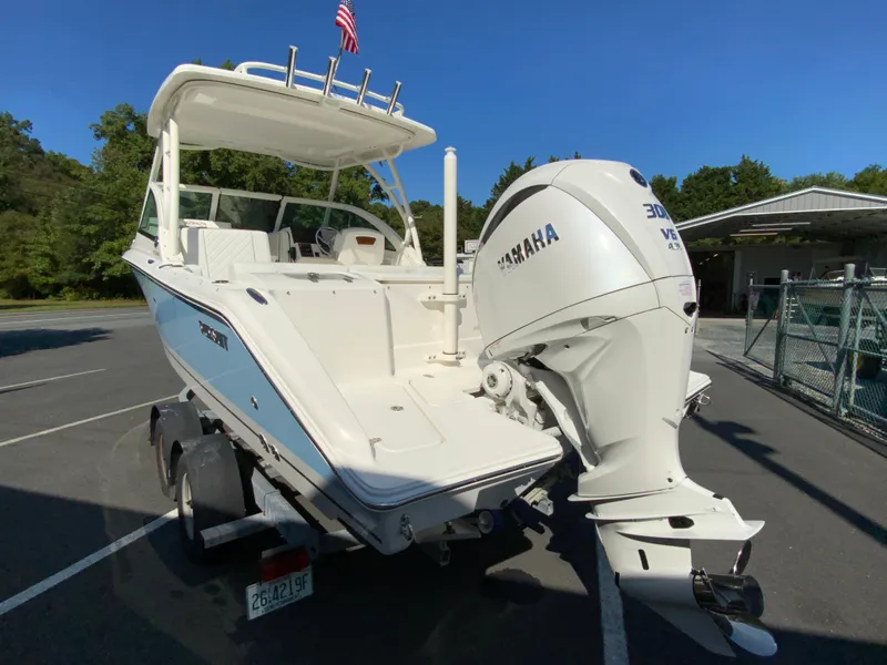 Slide: The Image of 2025 Pursuit DC 246 Dual Console boat with Yamaha engine in parking lot. - 7