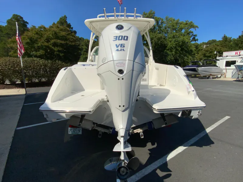 Slide: The Image of 2025 Pursuit DC 246 Dual Console boat with 300 V6 engine, parked outdoors. - 8