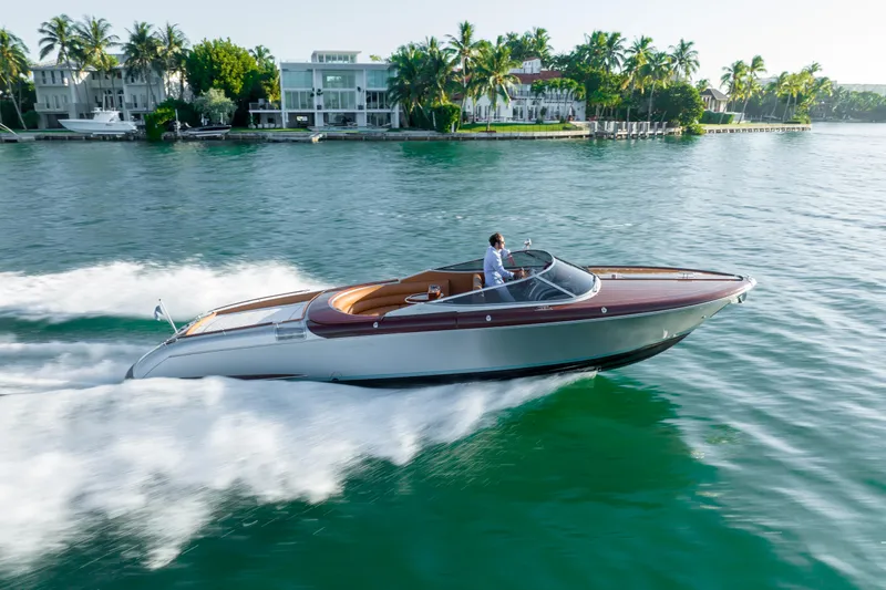 Slide: The Image of 2020 Riva Aquariva Super luxury speedboat cruising on a scenic waterfront. - 0