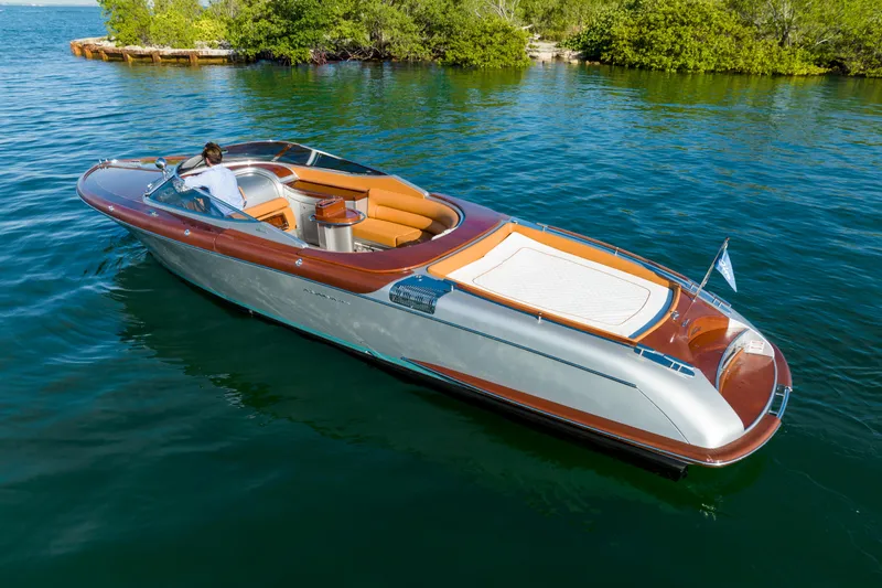 Slide: The Image of 2020 Riva Aquariva Super luxury motorboat cruising on a serene lake. - 12