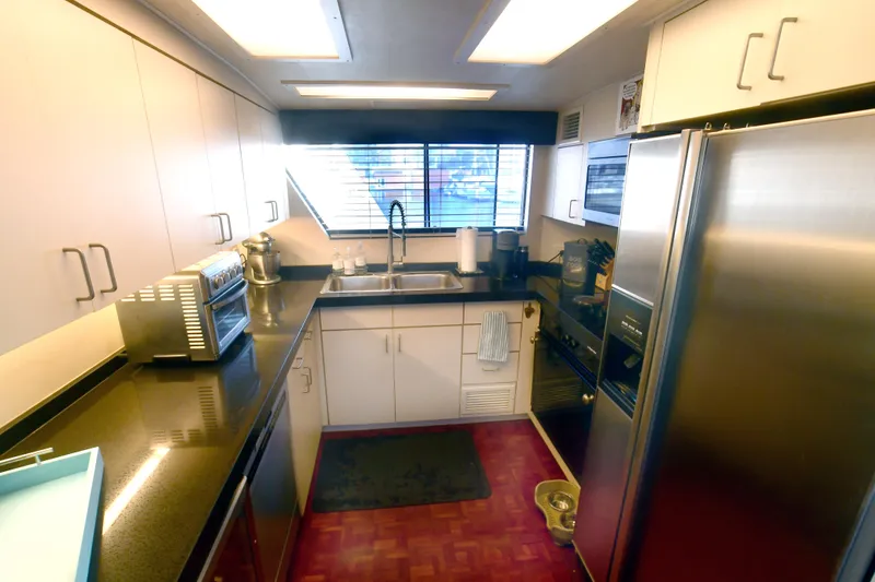 Slide: The Image of Modern kitchen interior of 1989 Hatteras 70 Cockpit Motor Yacht with stainless steel appliances. - 13