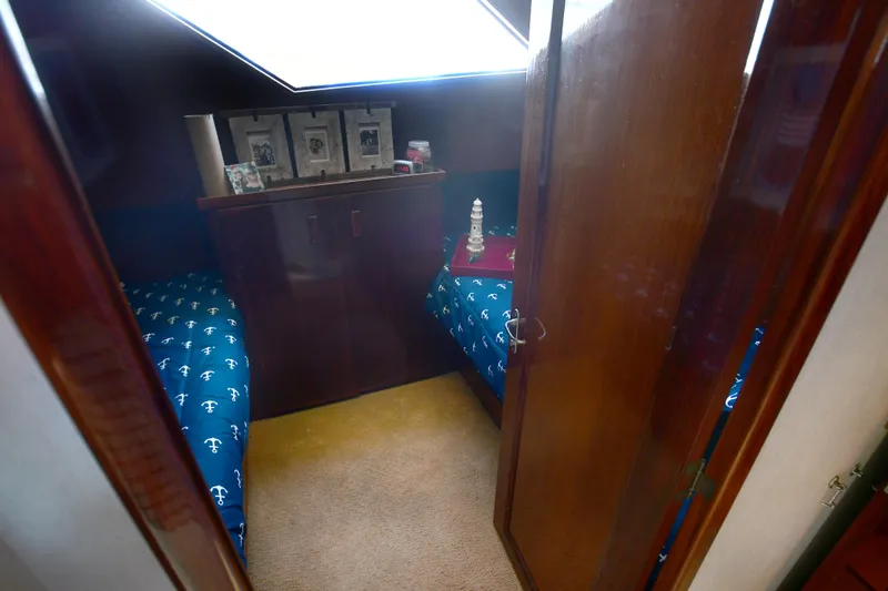 Slide: The Image of Interior cabin of 1989 Hatteras 70 Cockpit Motor Yacht with twin beds and nautical decor. - 16