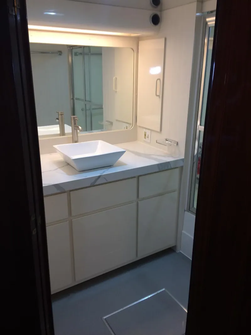 Slide: The Image of 1989 Hatteras 70 Cockpit Motor Yacht bathroom with modern sink and vanity. - 17