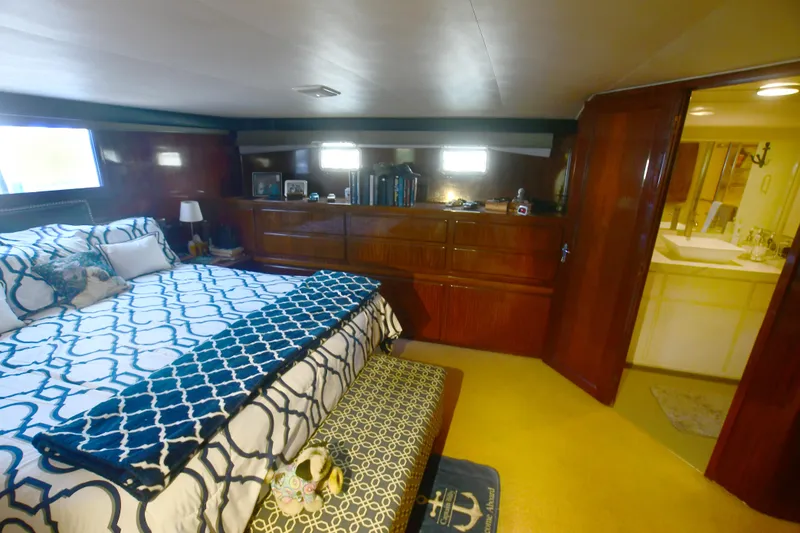 Slide: The Image of Luxurious bedroom in 1989 Hatteras 70 Cockpit Motor Yacht with elegant decor. - 18