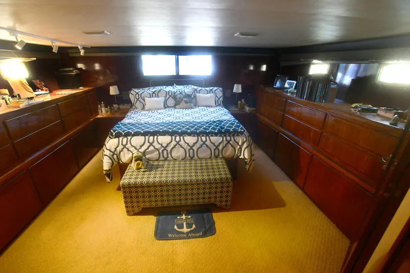 Slide: The Image of Luxurious bedroom interior of 1989 Hatteras 70 Cockpit Motor Yacht with elegant wood cabinetry. - 21