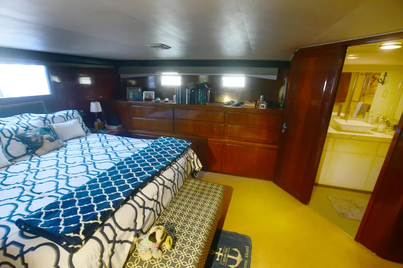 Slide: The Image of Luxurious bedroom in 1989 Hatteras 70 Cockpit Motor Yacht with elegant wood cabinetry. - 22