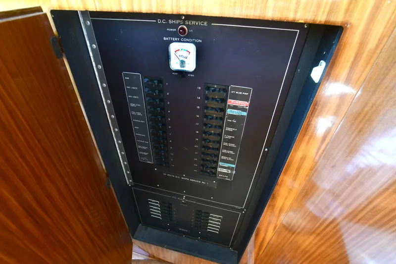 Slide: The Image of Electrical panel on 1989 Hatteras 70 Cockpit Motor Yacht, featuring battery condition gauge. - 28