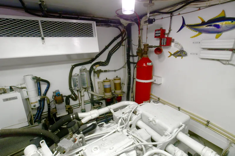 Slide: The Image of Engine room of 1989 Hatteras 70 Cockpit Motor Yacht with equipment and safety features. - 33