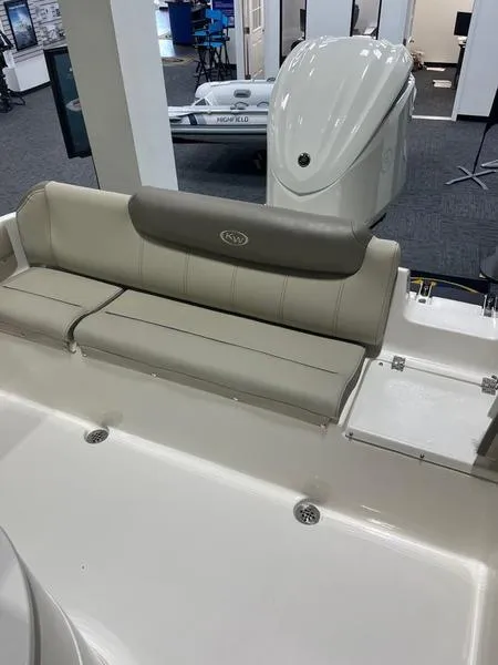 Slide: The Image of 2025 Key West 239 FS boat interior with cushioned seating and storage compartments. - 5