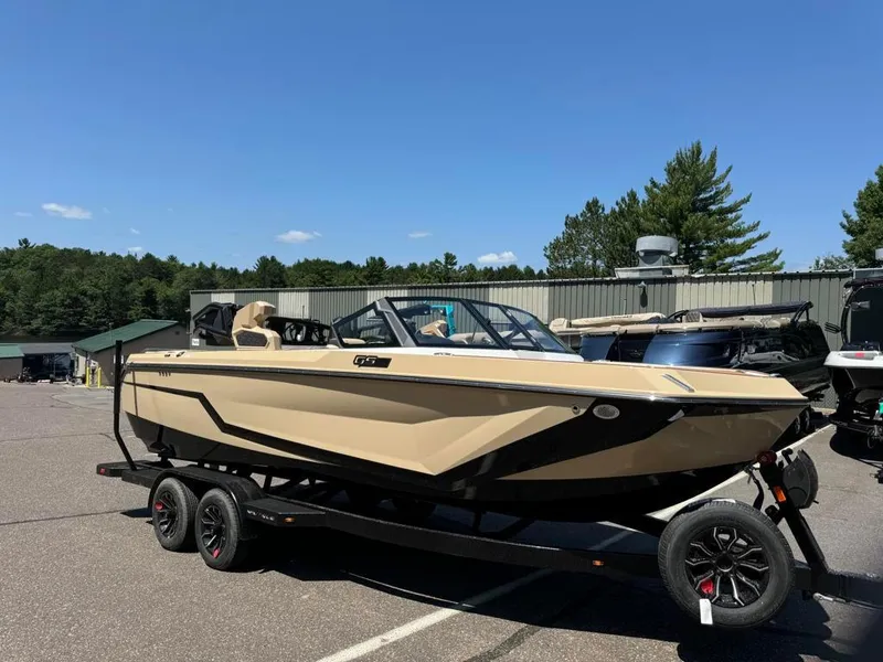 Slide: The Image of 2025 Nautique Super Air GS22 boat on trailer in sunny outdoor setting. - 10