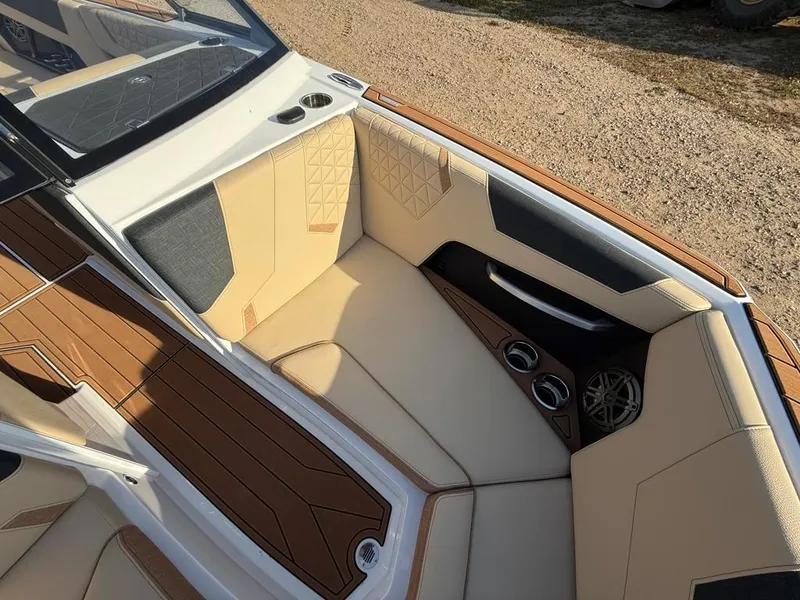 Slide: The Image of 2025 Nautique Super Air GS22 boat interior with tan and brown seating. - 14