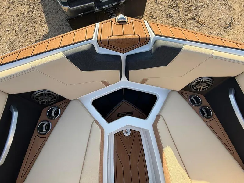 Slide: The Image of 2025 Nautique Super Air GS22 boat interior with tan upholstery and wood accents. - 18
