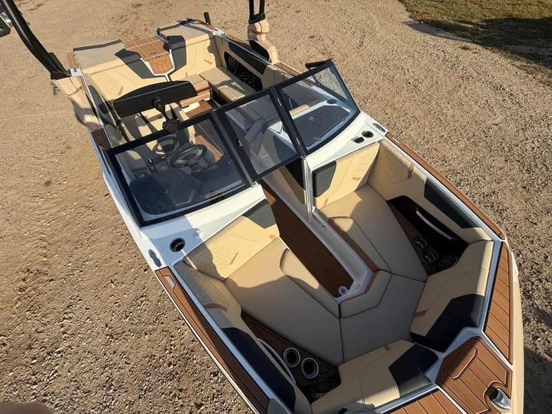 Slide: The Image of 2025 Nautique Super Air GS22 boat with luxurious seating and sleek design. - 19