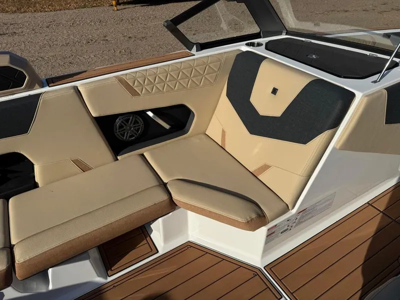Slide: The Image of 2025 Nautique Super Air GS22 boat interior with beige and black seating. - 21