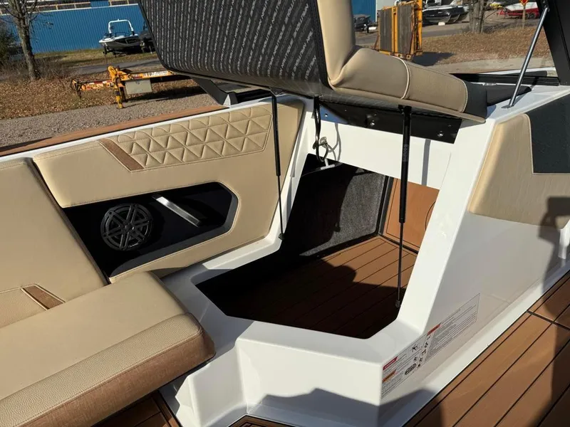 Slide: The Image of 2025 Nautique Super Air GS22 interior seating and storage compartment. - 23