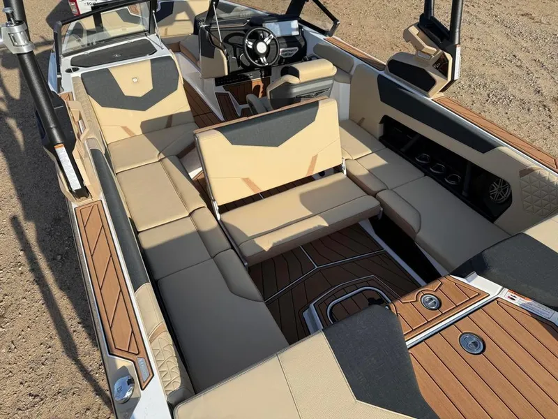 Slide: The Image of 2025 Nautique Super Air GS22 interior with beige seating and modern dashboard design. - 27