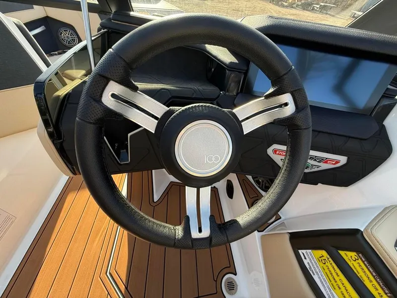 Slide: The Image of 2025 Nautique Super Air GS22 steering wheel and dashboard close-up. - 31