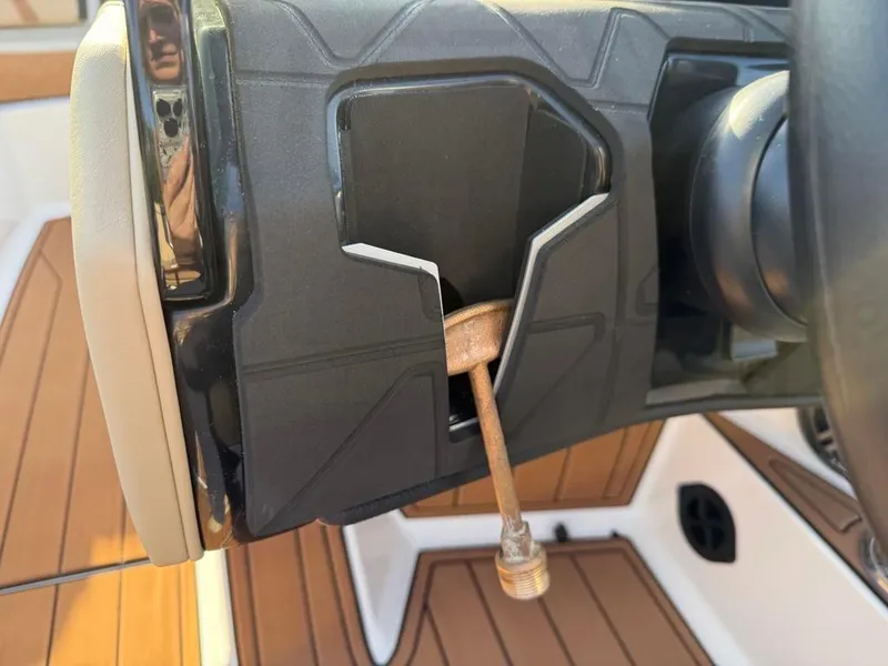 Slide: The Image of 2025 Nautique Super Air GS22 steering wheel detail with wooden handle. - 32