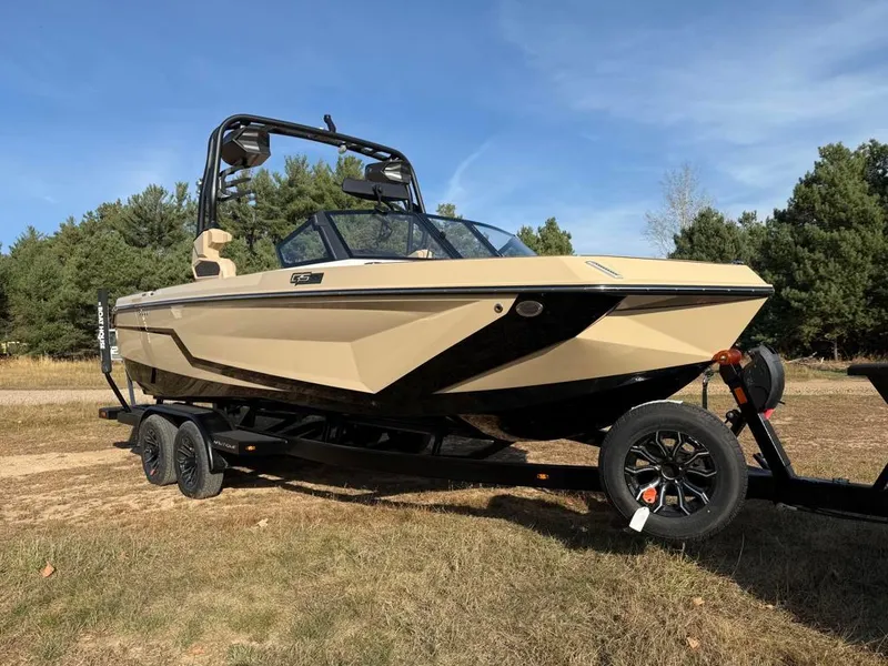 Slide: The Image of 2025 Nautique Super Air GS22 boat on trailer, parked outdoors. - 4