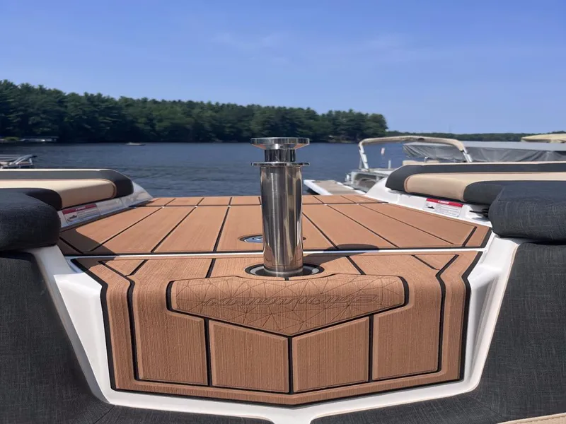 Slide: The Image of 2025 Nautique Super Air GS22 boat on a lake with teak deck. - 41