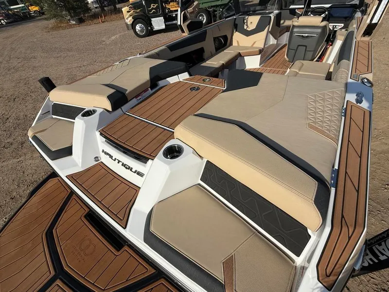 Slide: The Image of 2025 Nautique Super Air GS22 boat with luxurious seating and teak flooring. - 43