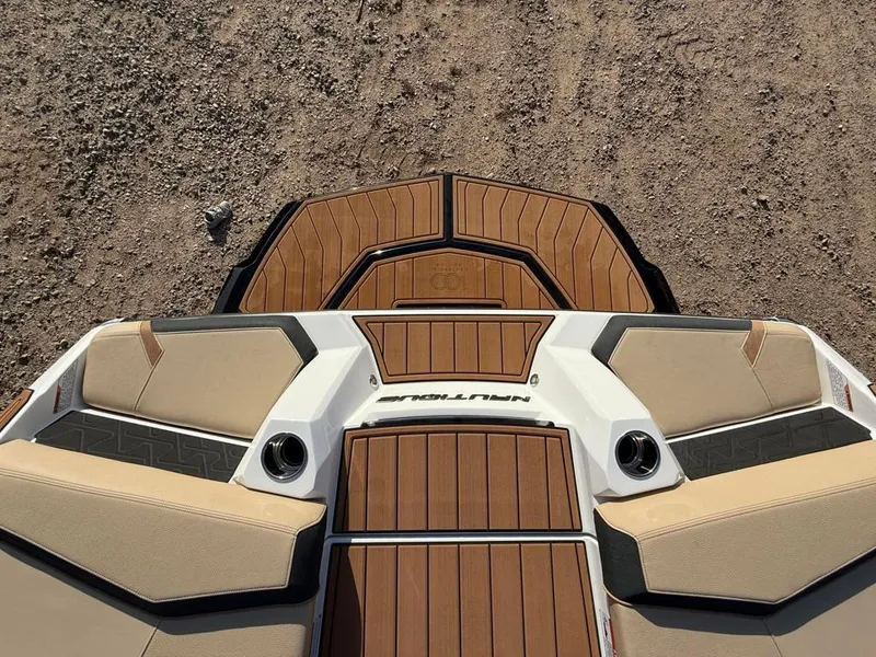 Slide: The Image of 2025 Nautique Super Air GS22 boat interior with tan seating and wood accents. - 44