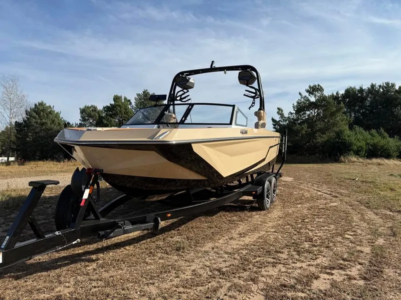 Slide: The Image of 2025 Nautique Super Air GS22 boat on trailer in outdoor setting. - 5