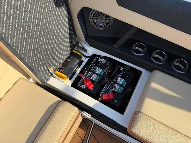 Slide: The Image of 2025 Nautique Super Air GS22 battery compartment with dual batteries and wiring. - 51