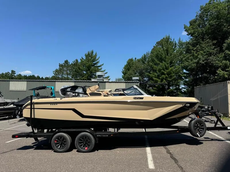 Slide: The Image of 2025 Nautique Super Air GS22 boat on trailer, parked outdoors. - 7