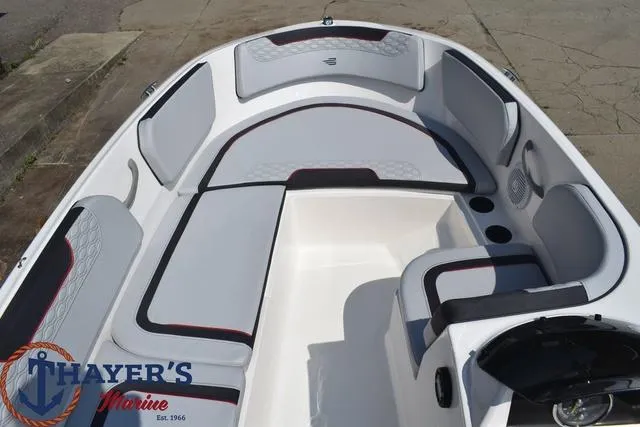 Slide: The Image of 2024 Bayliner M15 boat interior with seating and Thayer's Marine logo. - 11
