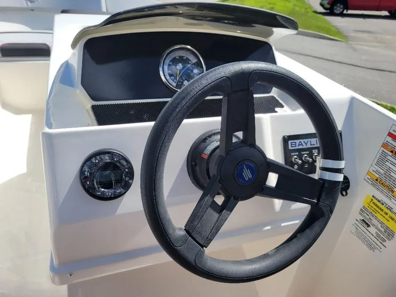 Slide: The Image of 2024 Bayliner M17 boat steering console with gauges and controls. - 11