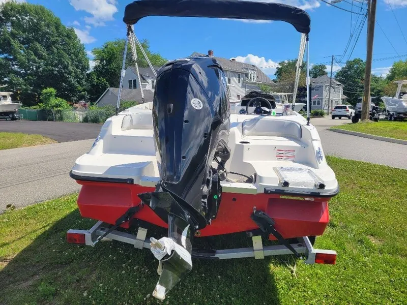 Slide: The Image of 2024 Bayliner M17 boat with outboard motor on trailer, parked on grass. - 4