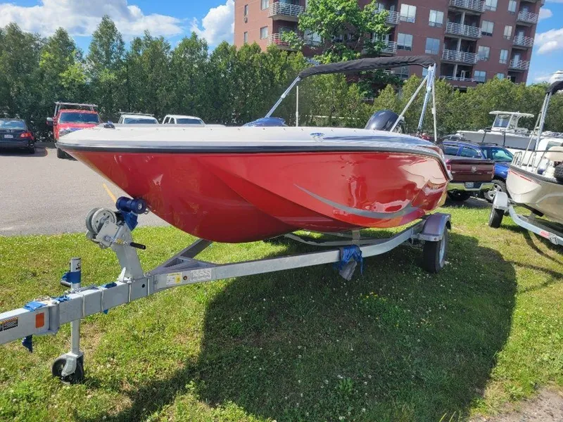 Slide: The Image of 2024 Bayliner M17 red boat on trailer in outdoor lot. - 6