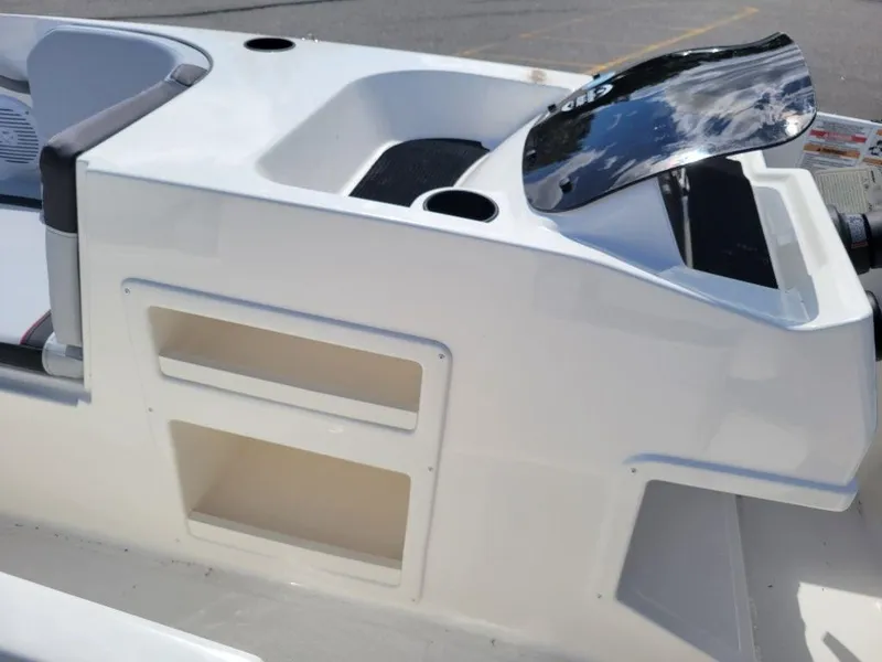 Slide: The Image of 2024 Bayliner M17 boat console with storage compartments and windshield. - 9