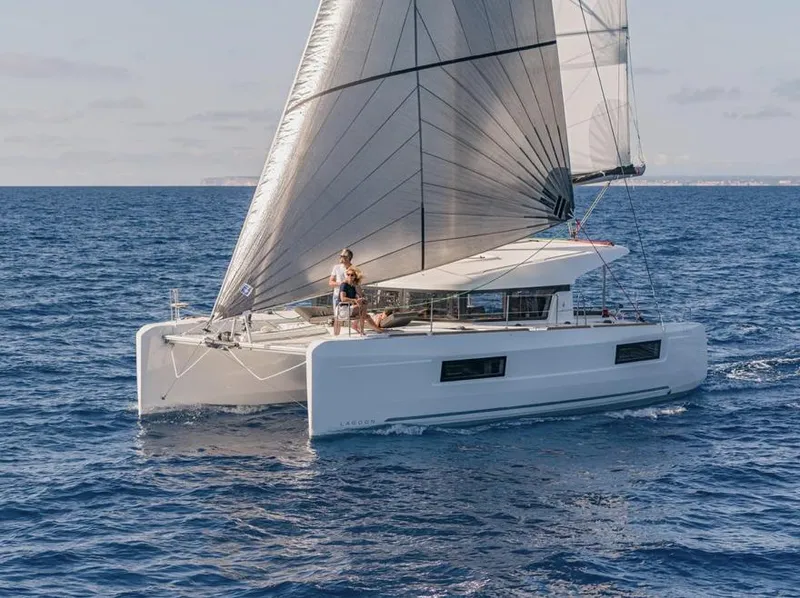Slide: The Image of 2020 Lagoon 40 catamaran sailing with passengers on deck, enjoying the ocean view. - 12