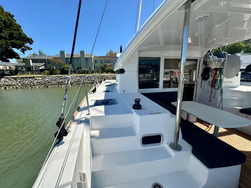 Slide: The Image of Family enjoying sailing on a 2020 Lagoon 40 catamaran in sunny weather. - 17