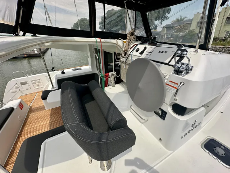 Slide: The Image of 2020 Lagoon 40 catamaran docked, showcasing spacious deck and seating area. - 19