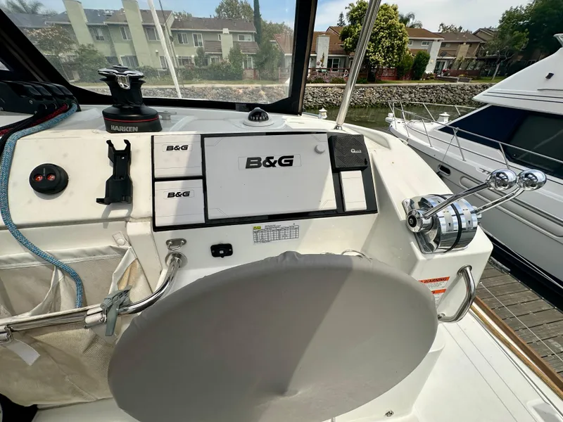 Slide: The Image of 2020 Lagoon 40 catamaran cockpit with seating, helm, and marina view. - 20