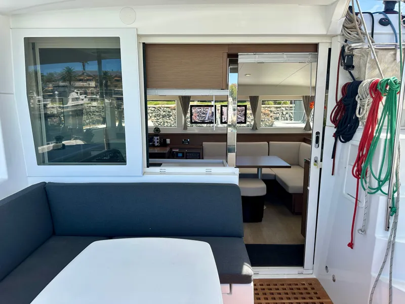 Slide: The Image of 2020 Lagoon 40 catamaran deck with seating, docked at marina with yachts. - 32