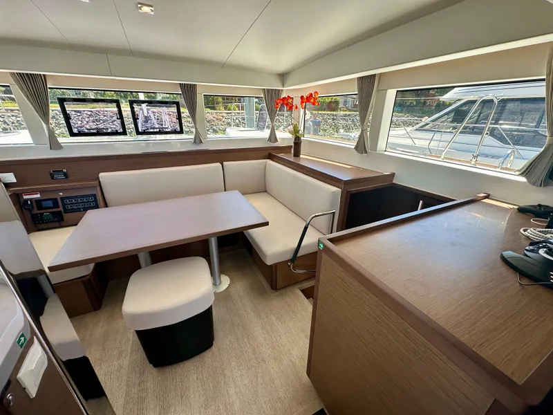 Slide: The Image of Interior of 2020 Lagoon 40 catamaran, featuring modern kitchen and dining area with ample seating. - 36