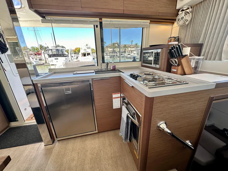 Slide: The Image of Interior of 2020 Lagoon 40 catamaran with modern kitchen and dining area. - 47