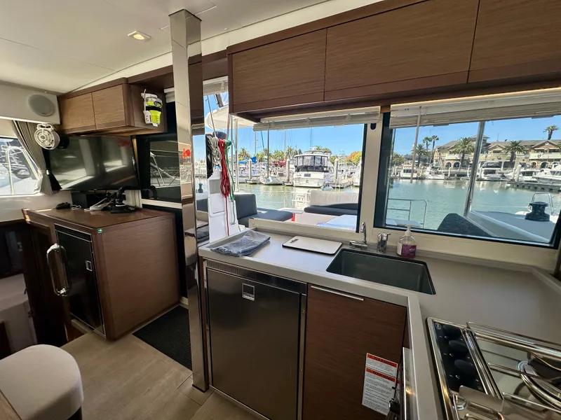 Slide: The Image of Modern interior of 2020 Lagoon 40 catamaran with dining area and marina view. - 48