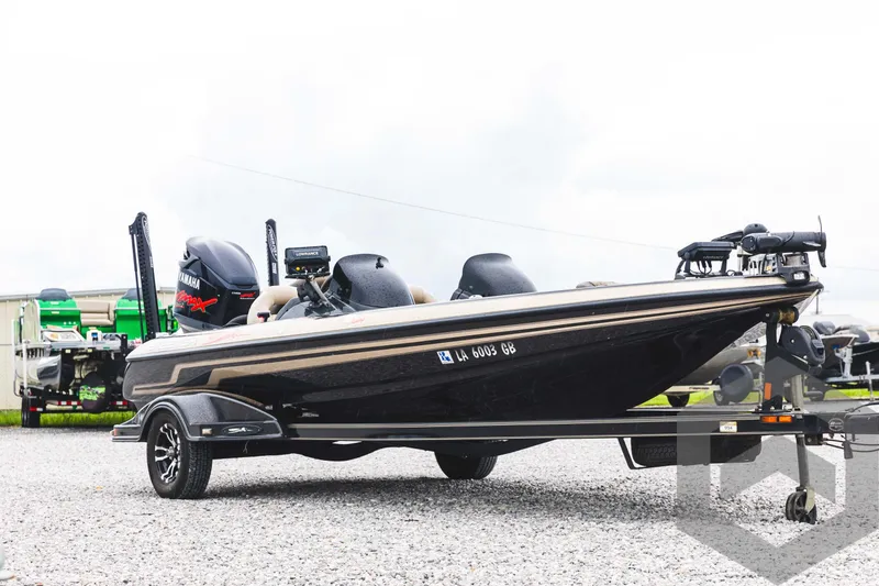 Slide: The Image of 2009 Skeeter ZX 200 bass boat on a trailer, parked on gravel. - 3