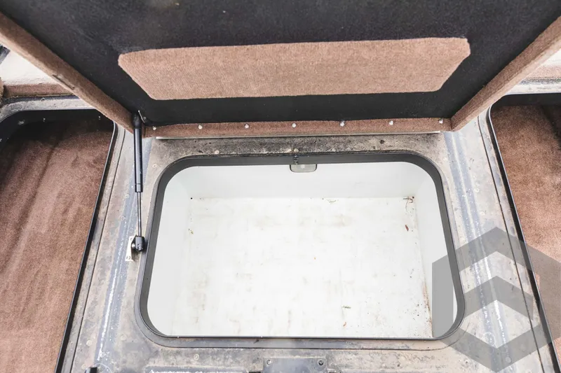 Slide: The Image of Open storage compartment of a 2009 Skeeter ZX 200 boat. - 32