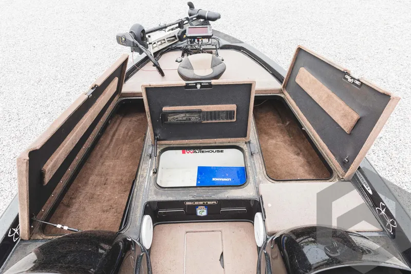 Slide: The Image of 2009 Skeeter ZX 200 boat with open storage compartments and fishing equipment. - 33